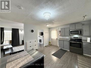 Windsor apartment for rent - A kitchen with a stove top oven and microwave.