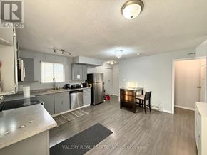 Windsor apartment for rent - A kitchen with stainless steel appliances and a dining table with chairs.