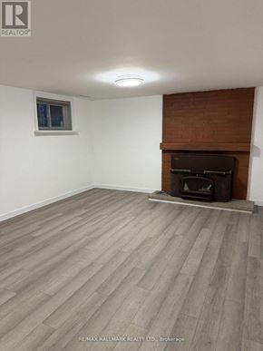 Toronto (Tam O'shanter-Sullivan) apartment for rent - A room with a fireplace and wooden flooring.