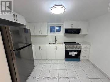 Toronto (Tam O'shanter-Sullivan) apartment for rent - A kitchen with white cabinets and a stainless steel refrigerator.