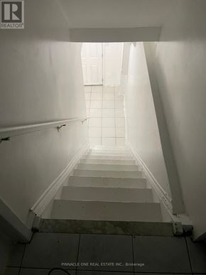 Toronto (Malvern) apartment for rent - A staircase leading to a bright light at the top.