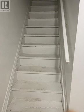 Toronto (Malvern) apartment for rent - A staircase with a white railing and steps.