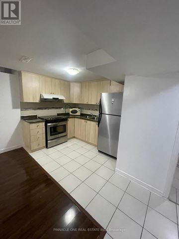 Toronto (Malvern) apartment for rent - A kitchen with a refrigerator, oven, and microwave.