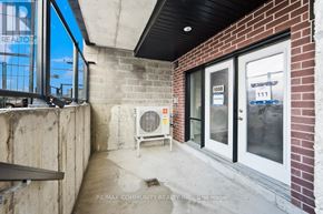 St. Catharines (E. Chester) townhouse for rent - A view of a building entrance with a glass door and a bench outside.