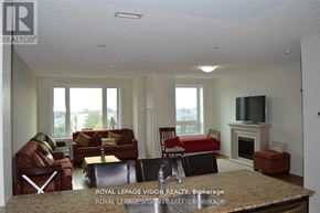Markham (Middlefield) condo for rent - A living room with a fireplace and a television.