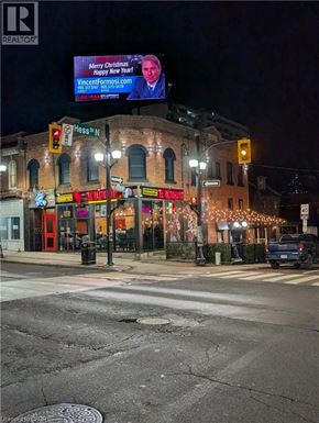 Hamilton apartment for rent - A street view with a billboard that says "Merry Christmas" and a website address.
