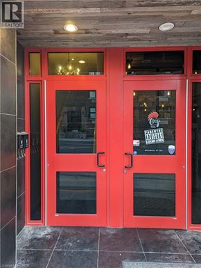 Hamilton apartment for rent - A red door with a glass window and a sign that says "PARENTAL ADVISORY".