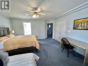 Burnaby apartment for rent - A bedroom with two beds and a ceiling fan.