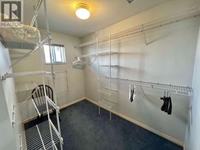 Burnaby apartment for rent - A room with a lot of shelves and a chair.