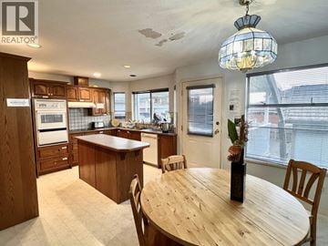Burnaby apartment for rent - A kitchen with wooden cabinets and a dining table.