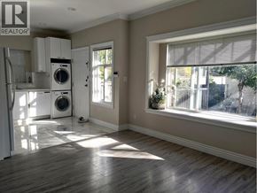 Vancouver apartment for rent - A sunny room with a washer and dryer in it.