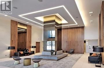 Toronto (Flemingdon Park) condo for rent - A modern living room with a television and a fireplace.
