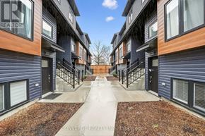 Welland (N. Welland) townhouse for rent - A row of modern townhouses with a central walkway between them.