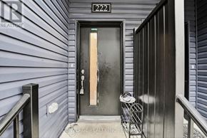 Welland (N. Welland) townhouse for rent - A black door with a glass window and a number 222 above it.