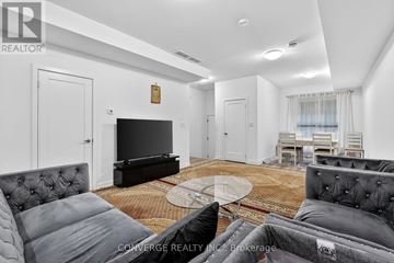 Welland (N. Welland) townhouse for rent - A living room with a grey couch and a glass coffee table.