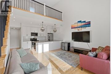 Ottawa townhouse for rent - A living room with a grey couch and a pink couch.