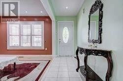 Toronto (Rouge) apartment for rent - A hallway with a mirror and a door.
