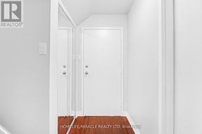 Toronto (West Hill) townhouse for rent - A hallway with two doors and a brokerage logo.