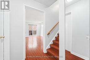 Toronto (West Hill) townhouse for rent - A hallway with a staircase leading to a second floor.