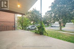 Toronto (Newtonbrook West) apartment for rent - A parking lot with a building and a tree in the background.