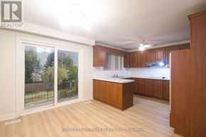 Toronto (Newtonbrook West) apartment for rent - A kitchen with wooden cabinets and a large island in the middle.
