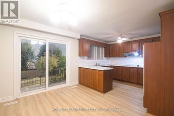Toronto (Newtonbrook West) apartment for rent - A kitchen with wooden cabinets and a large island in the middle.