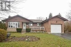 Oshawa (Northglen) apartment for rent - A house with a white garage door and a brick exterior.