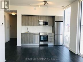 Toronto (Church-Yonge Corridor) condo for rent - A kitchen with a stainless steel refrigerator, oven, and microwave.