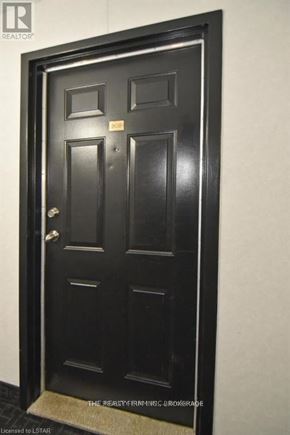 London South (South D) condo for rent - A black door with a gold handle and a small plaque on it.