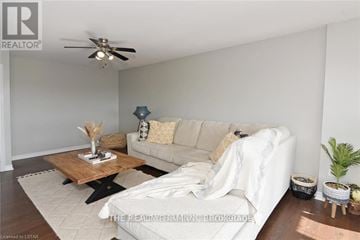 London South (South D) condo for rent - A living room with a white couch and a wooden coffee table.