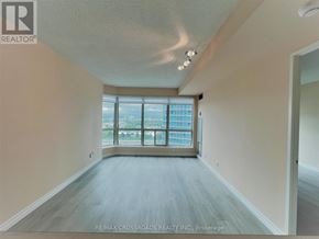 Toronto (Woburn) condo for rent - A spacious room with a large window overlooking a cityscape.