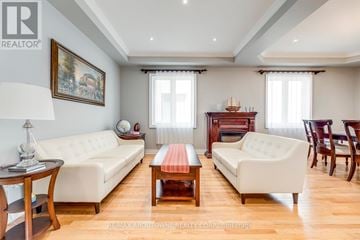 Oakville (Jc Joshua Creek) apartment for rent - A living room with a white sofa, a wooden coffee table, and a painting on the wall.
