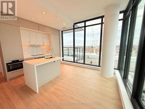 Toronto (Don Valley Village) condo for rent - A kitchen with a white island and wooden floors.