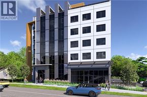 Waterloo condo for rent - A modern building with a blue car parked in front.