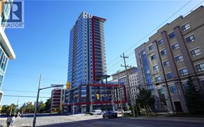 Waterloo condo for rent - A tall building with a blue sky in the background.