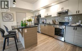 Waterloo condo for rent - A modern kitchen with a wooden island and stainless steel appliances.