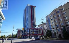 Waterloo condo for rent - A tall building with a blue sky in the background.
