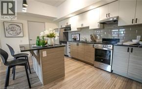 Waterloo condo for rent - A modern kitchen with a wooden island and stainless steel appliances.