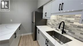 Welland apartment for rent - A kitchen with white cabinets and a sink.