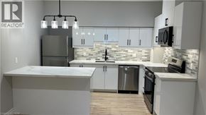 Welland apartment for rent - A modern kitchen with a large island and stainless steel appliances.