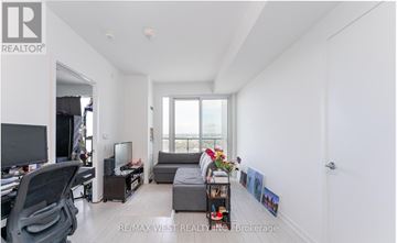 Vaughan (Vaughan Corporate Centre) condo for rent - A living room with a grey couch and a television.