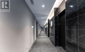 Vaughan (Vaughan Corporate Centre) condo for rent - A long hallway with a marble floor and walls.