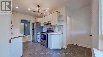 Toronto (Willowdale West) apartment for rent - A kitchen with white cabinets and a tile floor.