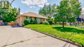 Toronto (Willowdale West) apartment for rent - A house with a brown roof and a green lawn in front.