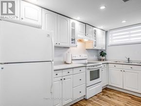Toronto (Rexdale-Kipling) apartment for rent - A white kitchen with a refrigerator, oven, and sink.