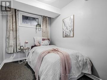 Toronto (Rexdale-Kipling) apartment for rent - A bedroom with a bed covered in a white and pink comforter.