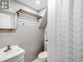 Toronto (Rexdale-Kipling) apartment for rent - A bathroom with a toilet, sink, and towel rack.