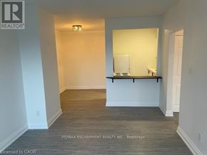 Hamilton (Ainslie Wood) condo for rent - A room with a white wall and a wooden floor.