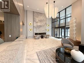 Hamilton (Corktown) condo for rent - A spacious living room with a fireplace and a large window.