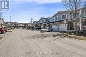 Barrie (Innis-Shore) townhouse for rent - A street view of a residential area with houses and parked cars.
